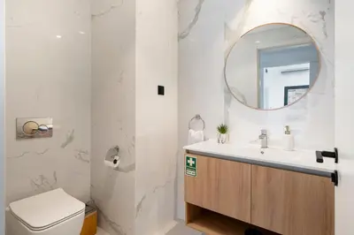 a bathroom with a toilet and a sink and a mirror at São Lucas II by An Island Apart in Funchal