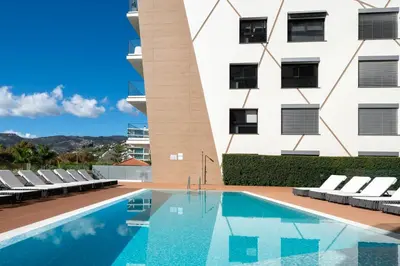 a swimming pool in front of a building at São Lucas II by An Island Apart in Funchal