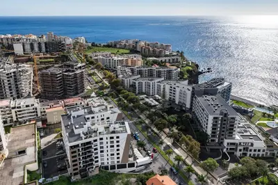 an aerial view of a city next to the ocean at São Lucas II by An Island Apart in Funchal