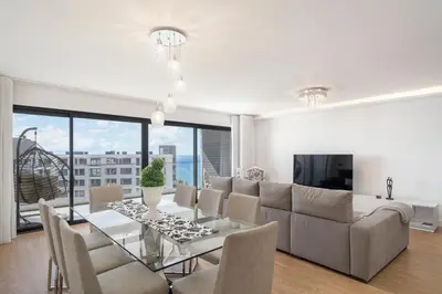 a living room with a couch and a table with chairs at São Lucas II by An Island Apart in Funchal