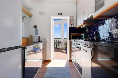 an open door to a kitchen with a view of the ocean at Arrifana Ocean View Villa in Aljezur