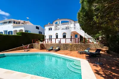 a house with a swimming pool in front of a house at Arrifana Ocean View Villa in Aljezur