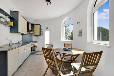 a kitchen with a table and chairs in a room at Arrifana Ocean View Villa in Aljezur