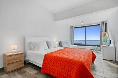 a bedroom with a bed and a large window at Matur Place in Machico in Machico