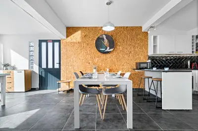a kitchen and dining room with a white table and chairs at Matur Place in Machico in Machico