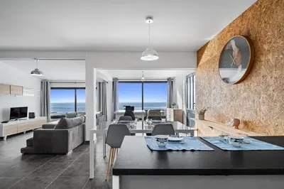 a living room with a table and a dining room at Matur Place in Machico in Machico