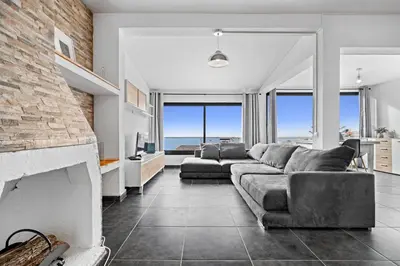 a living room with a couch and a fireplace at Matur Place in Machico in Machico