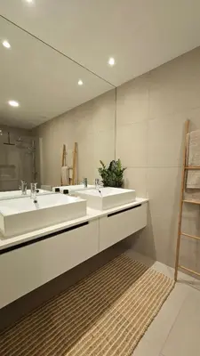 a bathroom with two sinks and a mirror at Urban Funchal Charming Apartment in Funchal