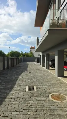 a brick sidewalk next to a building with a drain at Urban Funchal Charming Apartment in Funchal