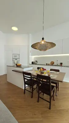 a kitchen with a table and chairs in a kitchen at Urban Funchal Charming Apartment in Funchal