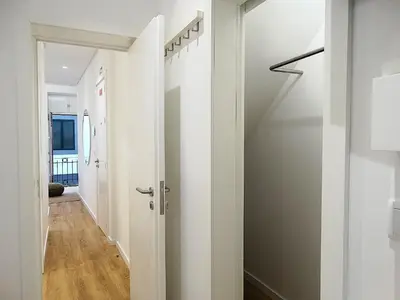 a hallway with white walls and a white door at CA Tanoeiros 1 in Funchal