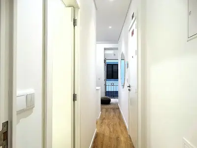 a hallway with white walls and a wooden floor at CA Tanoeiros 1 in Funchal