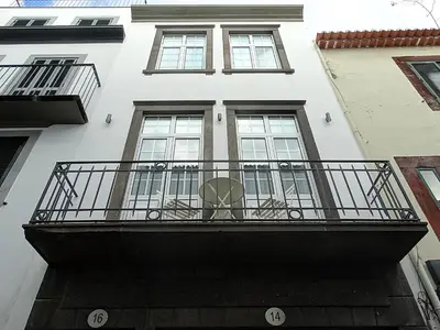 a balcony of a white building with windows at CA Tanoeiros 1 in Funchal
