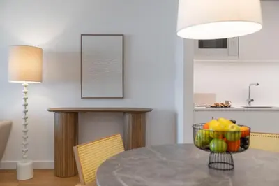 a dining room with a table with a bowl of fruit at Acqua Residence I by An Island Apart in Funchal