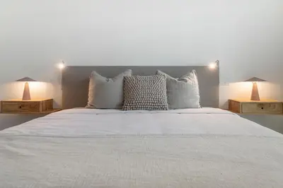 a bedroom with a large white bed with two lamps at Acqua Residence I by An Island Apart in Funchal