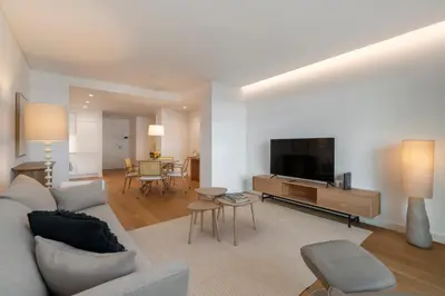 a living room with a couch and a flat screen tv at Acqua Residence I by An Island Apart in Funchal
