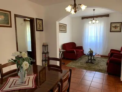 a living room with a table and a couch at Quinta da Colina in São Vicente