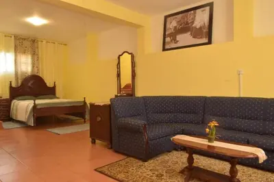 a living room with a couch and a bed at Quinta da Colina in São Vicente