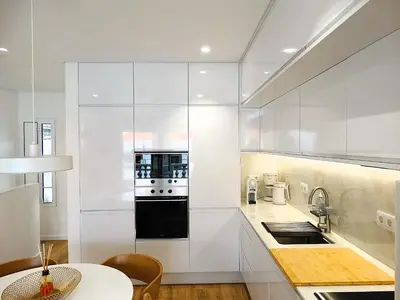 a kitchen with white cabinets and a stove top oven at CA Tanoeiros 2 in Funchal