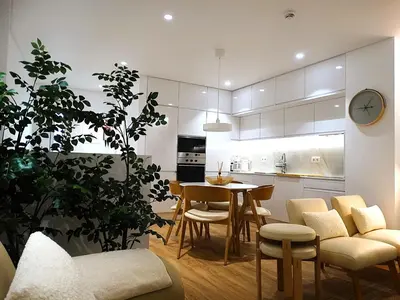 a kitchen and living room with a table and chairs at CA Tanoeiros 2 in Funchal