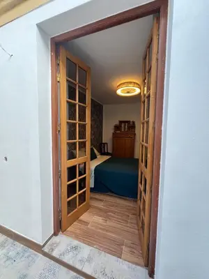 a bedroom with a bed with a patterned wall at Casa das Flores Funchal in Funchal