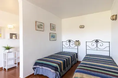 two beds in a room with white walls at Apartamento Branco Beliche in Sagres