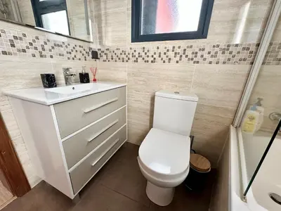 a small bathroom with a toilet and a sink at Private Rooftop Sunny Terrace in Funchal in Funchal