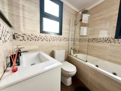 a bathroom with a sink and a toilet and a tub at Private Rooftop Sunny Terrace in Funchal in Funchal