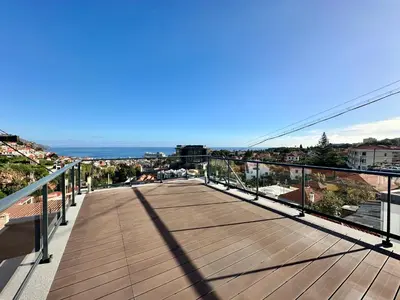 a balcony with a view of the ocean and buildings at Private Rooftop Sunny Terrace in Funchal in Funchal