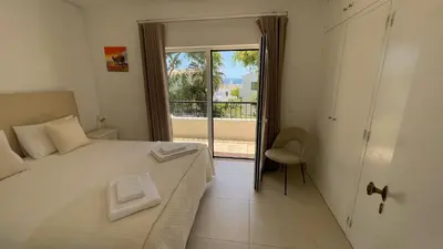 a bedroom with a bed with a window and a chair at Pipoca in Luz