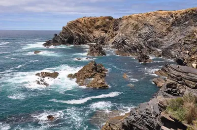 an aerial view of the ocean with rocks at Pipoca in Luz