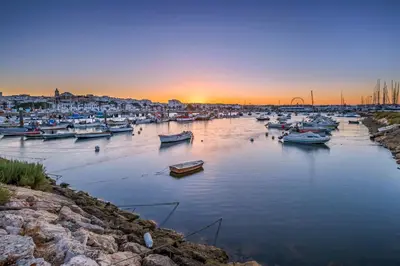 a group of boats in a harbor at sunset at Pipoca in Luz