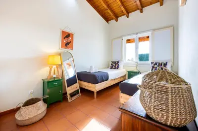 a room with a bedroom with a bed and a mirror at Casa Arafel in Aljezur