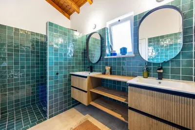 a bathroom with two sinks and a mirror at Casa Arafel in Aljezur