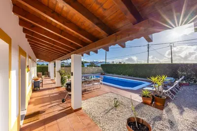 a patio with a swimming pool and a house at Casa Arafel in Aljezur