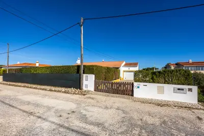 a house with a fence on the side of a road at Casa Arafel in Aljezur