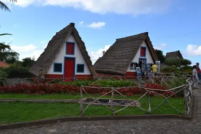 a small house with a thatched roof at Excellent Holiday Apartment in Caniço