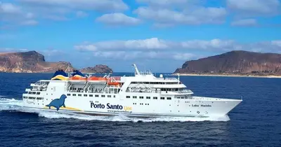 a cruise ship on the water with a mountain in the background at Excellent Holiday Apartment in Caniço