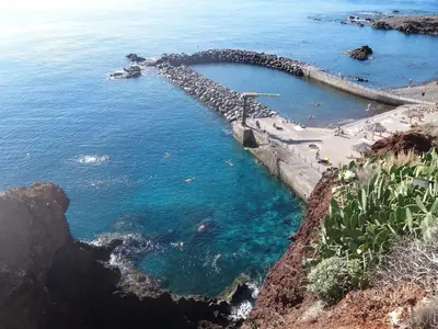 a group of people on a beach near the ocean at Excellent Holiday Apartment in Caniço