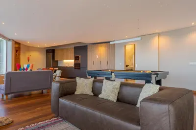 a living room with a couch and a pool table at A Porta das Neves in Funchal