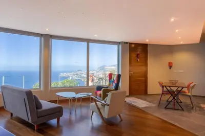 a living room with a view of the city at A Porta das Neves in Funchal