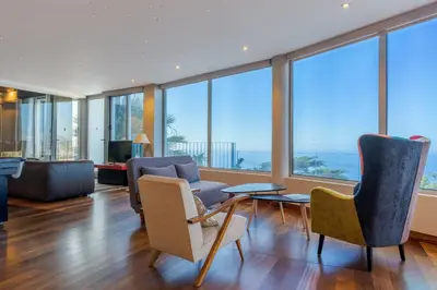 a living room with a view of the ocean at A Porta das Neves in Funchal