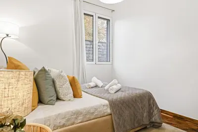 a white living room with a couch with pillows at Casa do Santo by Homie in Santo da Serra