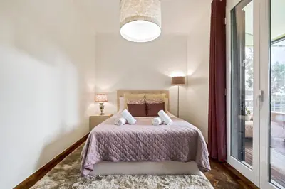 a bedroom with a bed with two towels on it at Casa do Santo by Homie in Santo da Serra