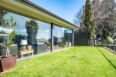 an extension to a house with a lawn at Casa do Santo by Homie in Santo da Serra
