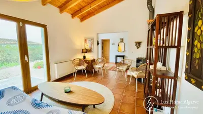 a living room with a table and chairs at CasaÂncora - Sea View Rooftop - 1km Beach - Garden in Raposeira