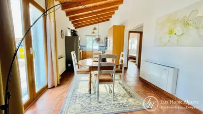 a dining room with a table and chairs at CasaÂncora - Sea View Rooftop - 1km Beach - Garden in Raposeira