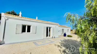 a white house with a pathway leading to it at CasaÂncora - Sea View Rooftop - 1km Beach - Garden in Raposeira