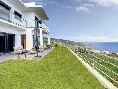 a balcony of a house with a view of the ocean at Rising Sun Villa in Gaula