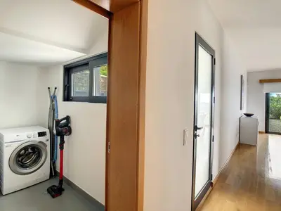 a laundry room with a washing machine and a window at Rising Sun Villa in Gaula